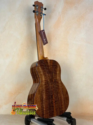 Beautiful Koa wood Kanile’a K-3 Tenor Ukulele displayed on a black stand