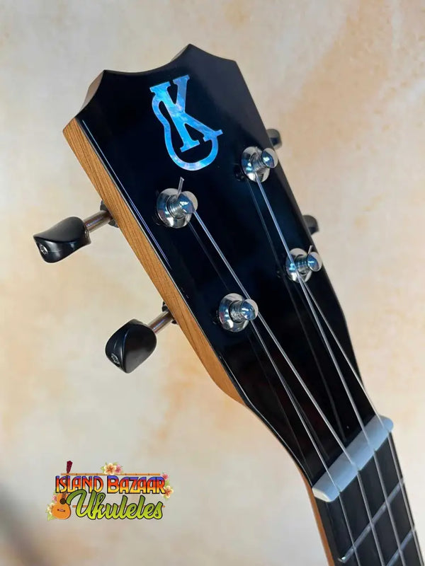 Black ukulele headstock of Kanile’a K-3 Tenor with blue logo and chrome tuners