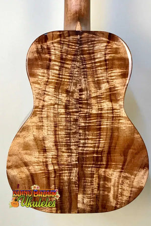 Acoustic guitar back panel of Kanilea K-3T Tenor showcasing deluxe koa with stunning grain