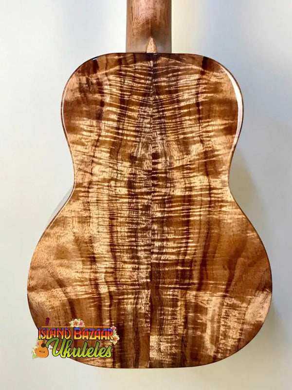 Acoustic guitar back panel of Kanilea K-3T Tenor showcasing deluxe koa with stunning grain