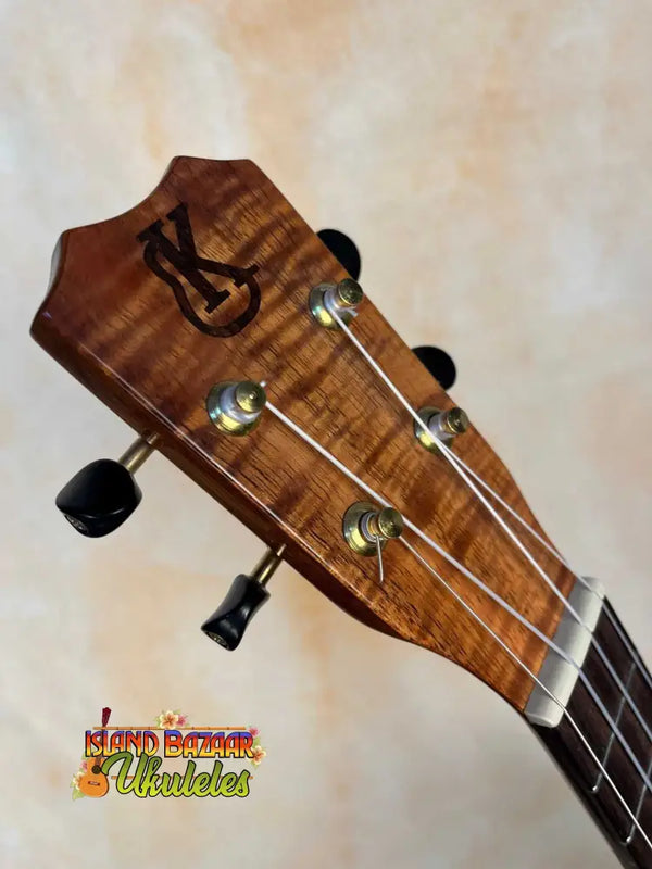 Wooden ukulele headstock with tuning pegs on Kanilea K1 Tenor Ukulele in Hawaiian Curly Premium Koa