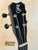 Black guitar headstock with silver tuning pegs and K logo from Kanilea K3-T Tenor Koa