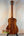 Wooden acoustic Kanile’a K3-T Tenor Koa Ukulele with rich brown finish and case