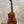 Kanileʻa koa core concert ukulele with glossy mahogany body and floral inlay featuring black tuning pegs