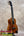 Kanileʻa koa core concert ukulele with glossy mahogany body and floral inlay featuring black tuning pegs