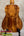 A kanileʻa honus tenor ukulele crafted from mahogany with a warm finish and intricate wood grain patterns with deluxe gig bag