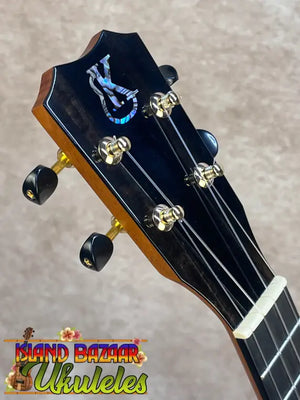 Black kanileʻa honus tenor ukulele headstock with blue white logo gold tuning pegs and black knobs