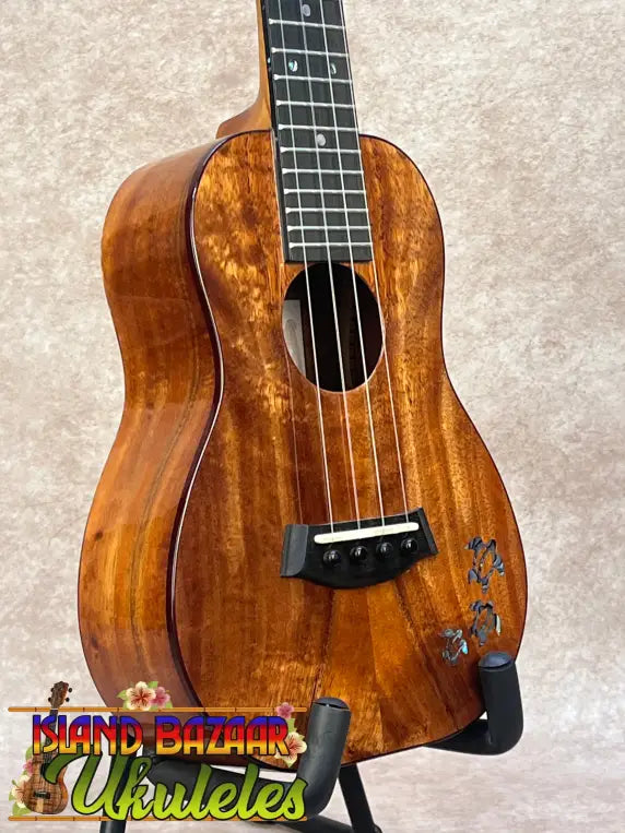 Kanileʻa koa core concert ukulele with warm polished wood and floral inlay, ideal for kanileʻa honus tenor players