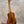 Kanileʻa koa core concert ukulele polished mahogany with golden tuning pegs on black stand for kanileʻa honus tenor fans