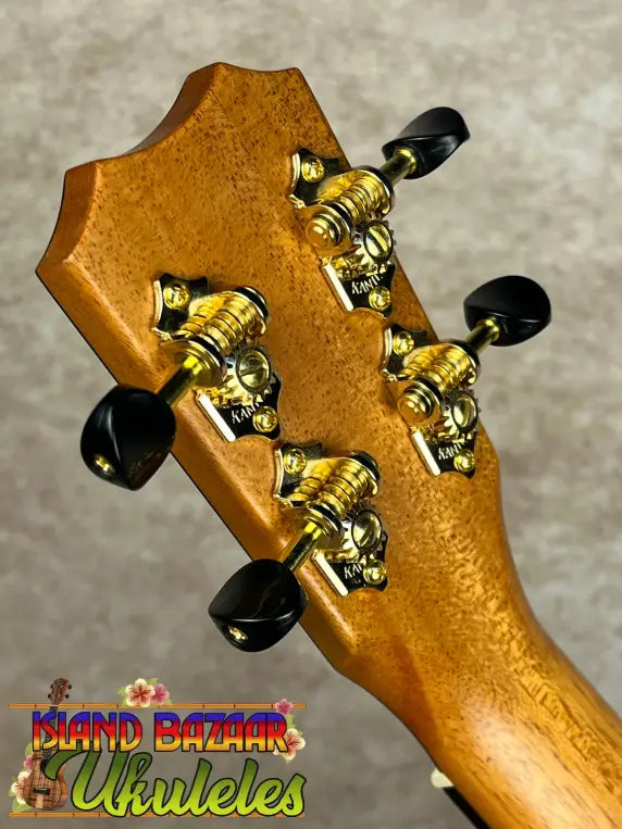 Back of Kanileʻa KPA-C Master Concert Ukulele headstock with gold tuners and black knobs