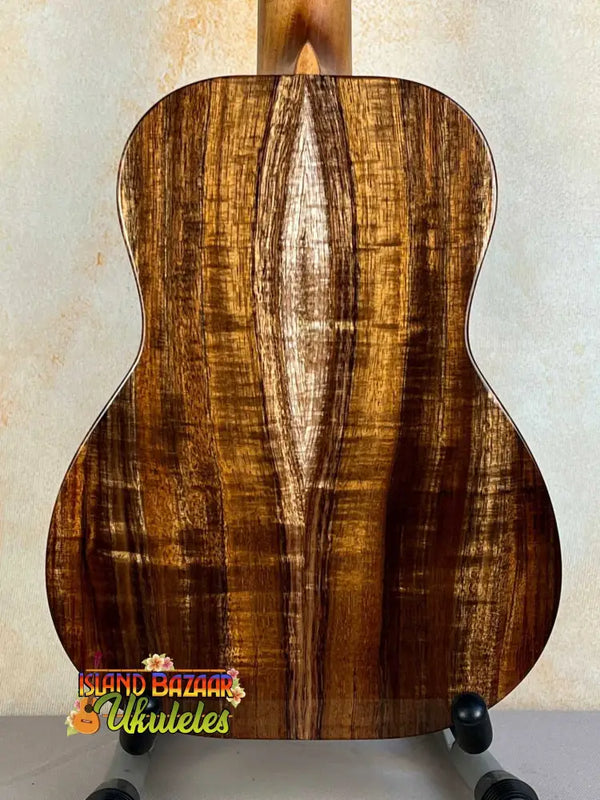 Acoustic guitar featuring rich brown striped wood grain of Kanilea KPA Curly Koa Tenor Ukulele