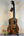 Beautiful Kanilea KPA Curly Koa Tenor Ukulele displayed on a stand