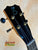 Black guitar headstock with tuning pegs on Kanilea KPA Curly Koa Tenor Ukulele