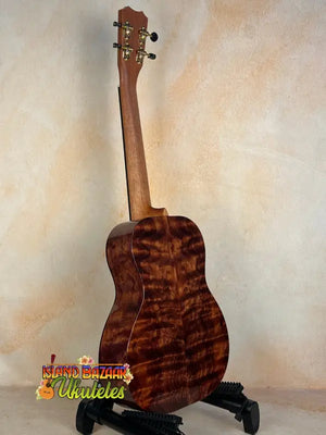Wooden Kanilea KPA Master-Grade Tenor Ukulele in Hawaiian Koa on black stand