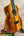 Vibrant orange-brown Kanile’a KPA Pro Tenor Koa Ukulele with abalone soundhole inlay