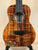 Ornate brown Kanile’a KPA Pro Tenor Koa Ukulele with Deluxe Gig Bag displayed elegantly