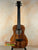 Brown wooden ukulele in Kanile’a KPA Pro Tenor Koa Ukulele with Deluxe Gig Bag