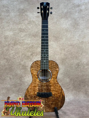 A kanile’a kpa pro tenor ukulele with premium solid hawaiian koa wood and black hardware in warm golden brown