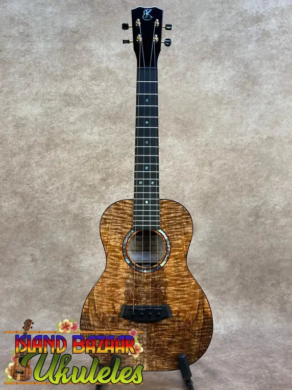 A kanile’a kpa pro tenor ukulele with premium solid hawaiian koa wood and black hardware in warm golden brown