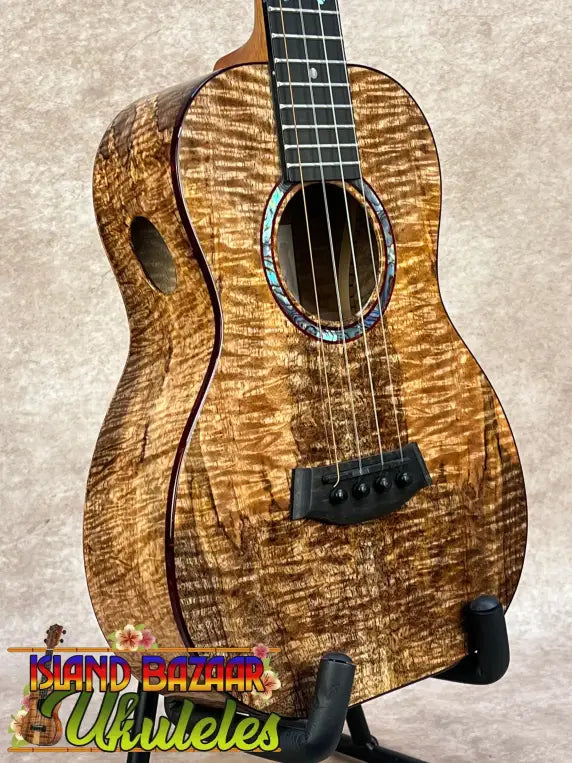 Kanileʻa kpa pro tenor ukulele with rich golden-brown solid mango body and iridescent abalone soundhole inlay