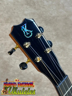 Black tenor ukulele headstock with iridescent inlay and gold tuning pegs from kanileʻa kpa pro premium solid mango