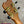 The headstock of a light brown solid mango kanilea kpa pro tenor ukulele with gold tuning machines and black pegs