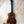 Brown wooden Kanilea KPA-T Prem Tenor Ukulele with black tuning pegs and strings