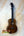Brown wooden Kanilea KPA-T Prem Tenor Ukulele with black tuning pegs and strings