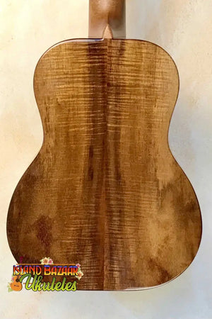 Wooden back panel of Kanilea KPA-T PREM tenor ukulele showcasing curly koa grain patterns