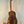 Wooden acoustic guitar on a black stand with Kanilea KPA-T Tenor Ukulele Hawaiian Koa