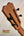 Wooden guitar headstock with black tuning pegs on Kanile’a KTR-T Master-Grade Koa Tenor Ukulele