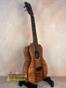 Beautiful Kanile’a KTR-T Master-Grade Koa Tenor Ukulele displayed on a black stand