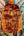Polished wooden surfboard with amber patterns and Kanile’a Pineapple Hawaiian Koa Tenor Ukulele