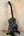 Black and gray Kanile’a KPA Pro Tenor Ukulele on a stand with deluxe gig bag