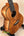 Beautiful Koa wood Kanile’a Premium Silk Tenor Ukulele K-2 on black stand
