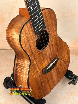 Beautiful Koa wood Kanile’a Premium Silk Tenor Ukulele K-2 on black stand