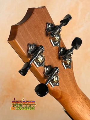 Guitar headstock with black tuning pegs on Kanile’a Premium Silk Tenor Ukulele K-2