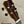 Brown wooden Kanile’a Super Tenor ukulele headstock with black tuning pegs and abalone inlay
