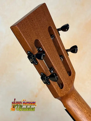 Wooden guitar headstock with black tuning pegs on Kanile’a Super Tenor Premium Koa Ukulele
