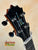 Guitar headstock of KoAloha Concert Hawaiian Ukulele with black tuning pegs and inlaid design