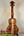 Wooden KoAloha Concert Hawaiian Ukulele in solid Hawaiian koa with rich grain on black stand