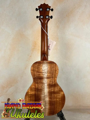 Wooden KoAloha Concert Hawaiian Ukulele in solid Hawaiian koa with rich grain on black stand