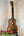 Wooden KoAloha KCM-10 Concert Ukulele in Solid Hawaiian Koa resting on a stand