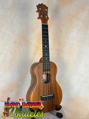 Wooden KoAloha KCM-10 Concert Ukulele in Solid Hawaiian Koa resting on a stand