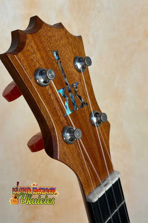 Wooden guitar headstock with tuning pegs and inlay on KoAloha KCM-10 Concert Ukulele