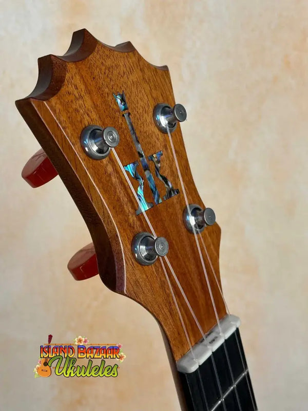 Wooden guitar headstock with tuning pegs and inlay on KoAloha KCM-10 Concert Ukulele