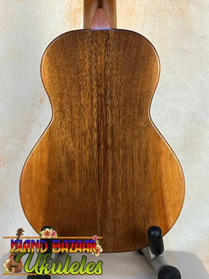 Wooden acoustic guitar in rich brown finish, showcasing KoAloha KCM-10 Concert Ukulele