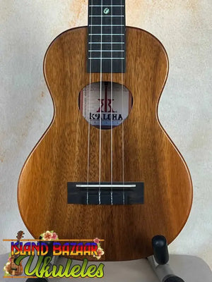 Wooden KoAloha KCM-10 Concert Ukulele in Solid Hawaiian Koa on a stand