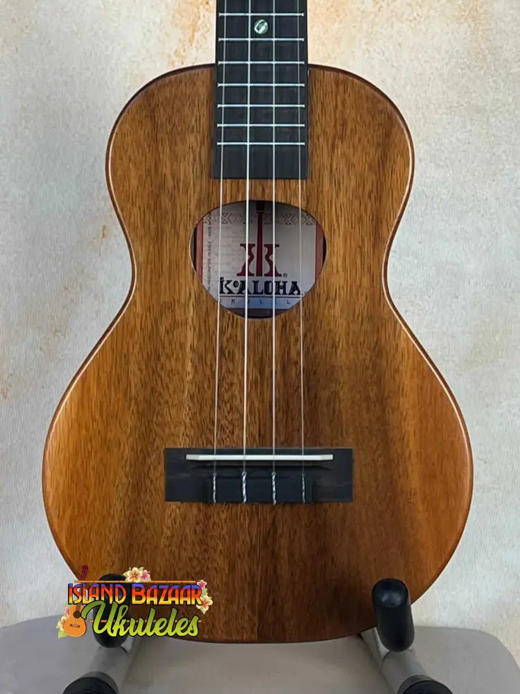 Wooden KoAloha KCM-10 Concert Ukulele in Solid Hawaiian Koa on a stand