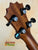 Guitar headstock with black tuning pegs and solid Hawaiian Koa featured in KoAloha KCM-10RP